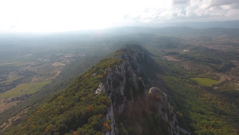 Pic-Saint-Loup-edge-summit-by-drone.-Cliff-with-valleys-around-aerial-view
